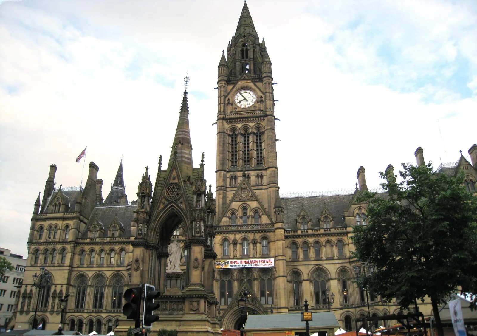 Manchester Town Hall's Gothic front on Albert Square, with the memorial in front.