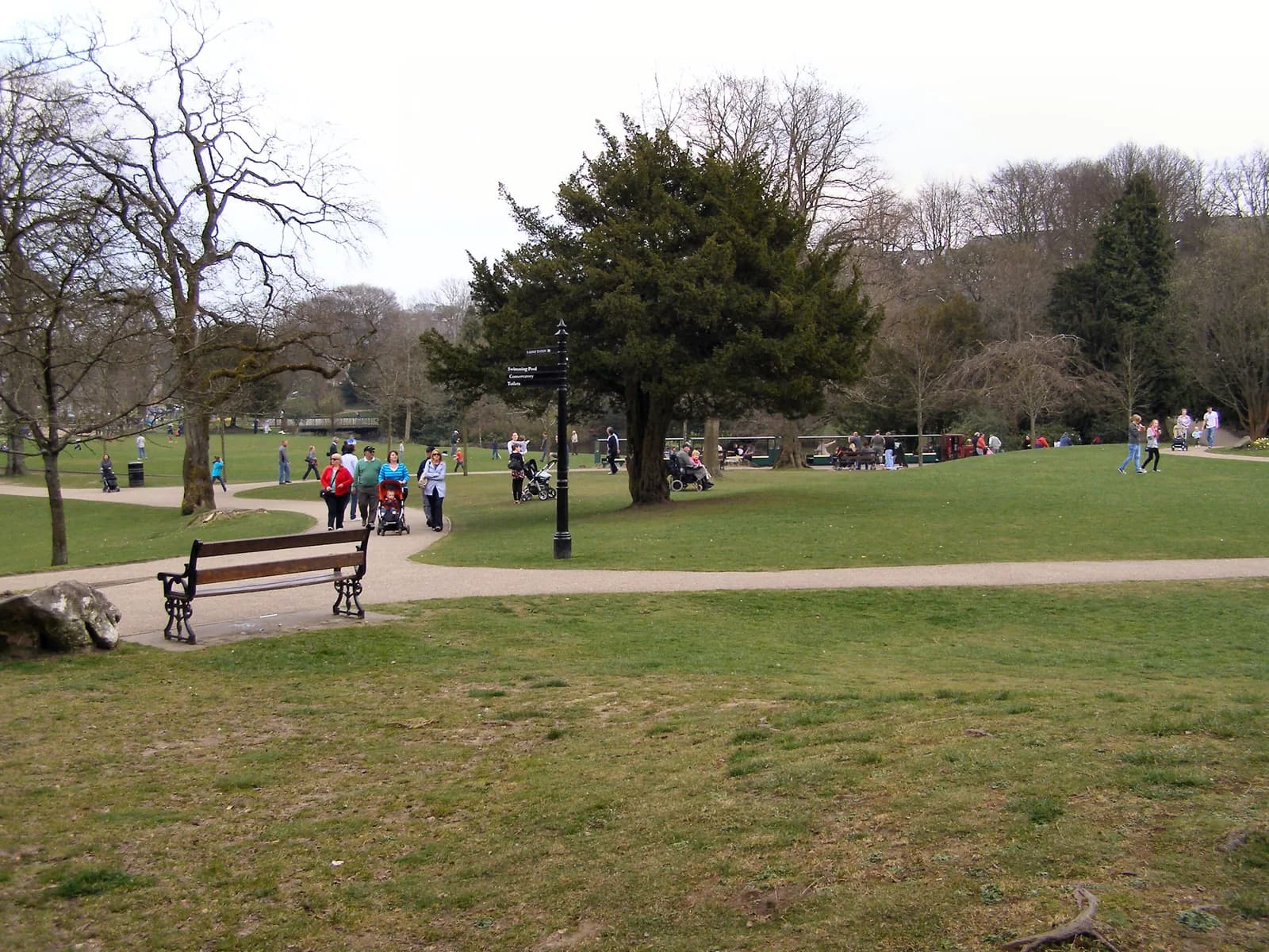 Buxton Pavilion Gardens with lawns, trees and the conservatory building