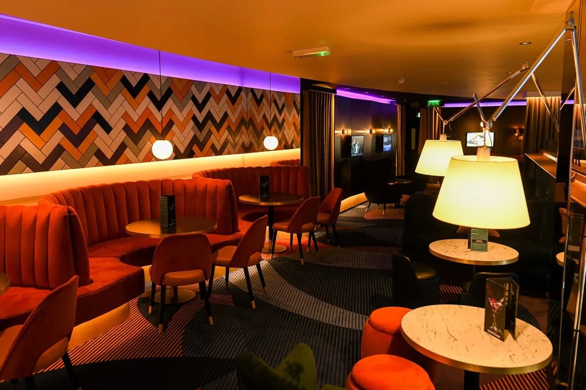 Showcase Cinema de Lux Leicester - lounge and bar seating area with orange banquettes and patterned feature wall