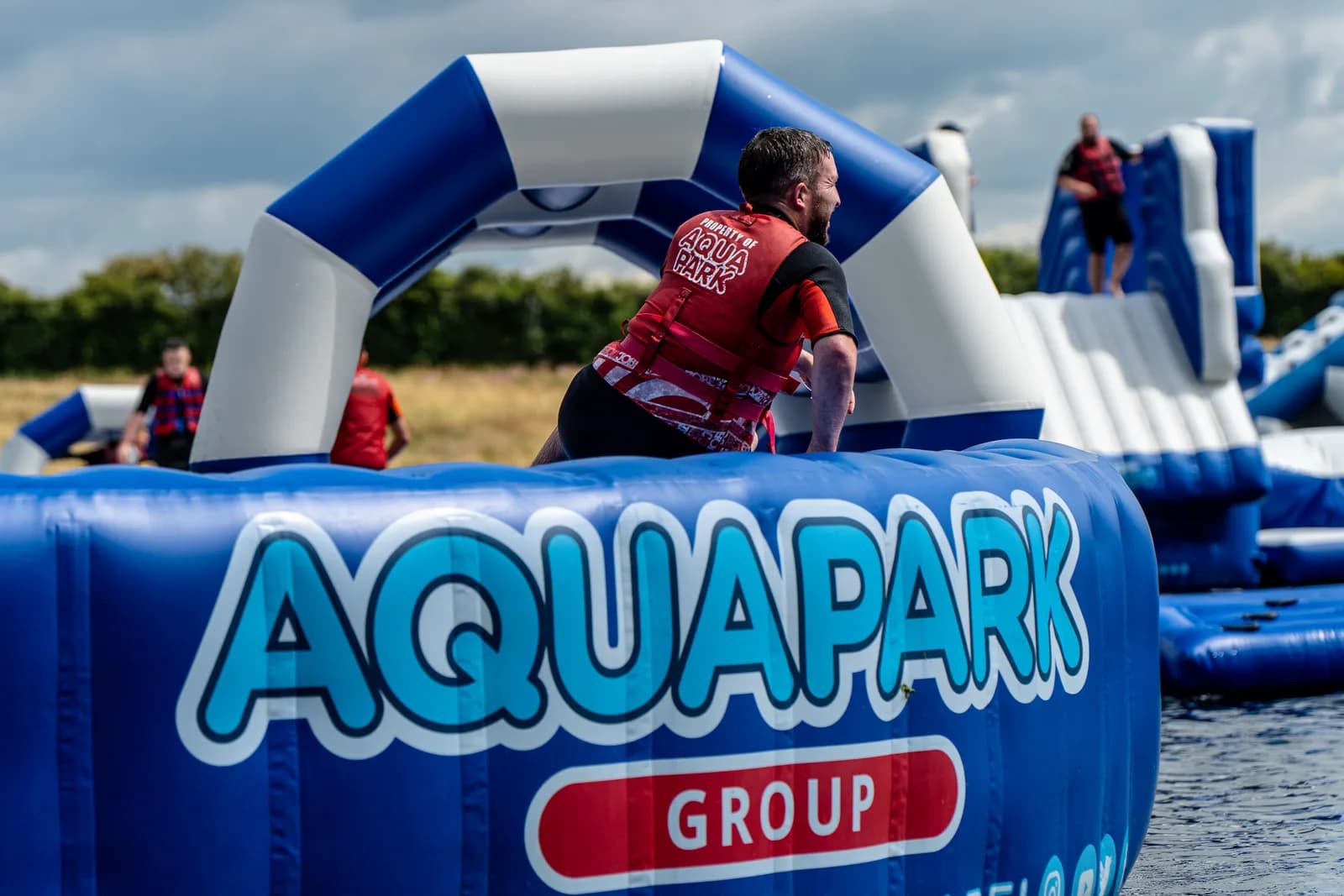 Visitors tackling the inflatable obstacle course at Aqua Park Rutland, Rutland Water