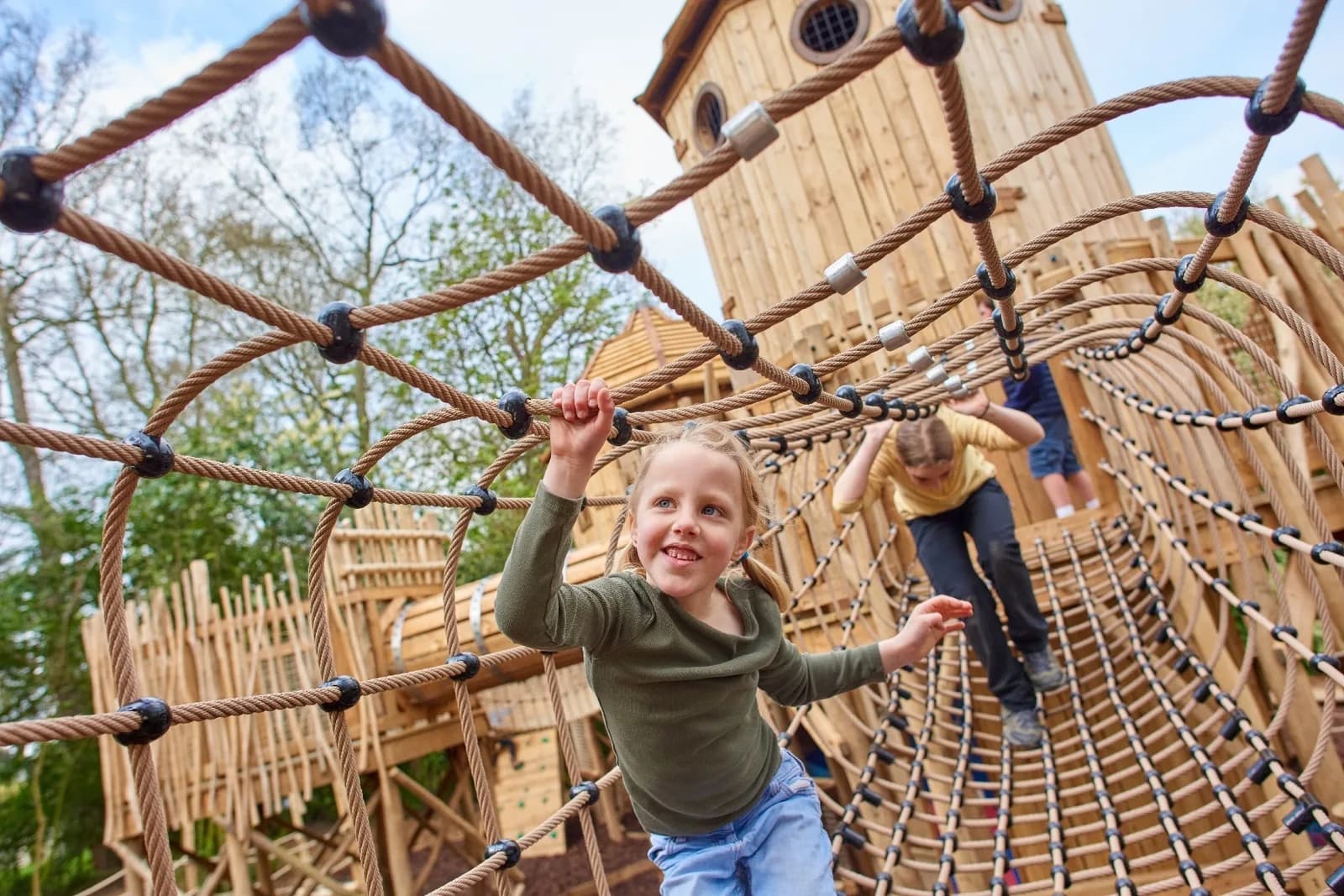 Children climbing at Hide & Secrets Adventure Play at Burghley House