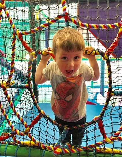 Child playing on the soft play structure at Fun Farm Grantham