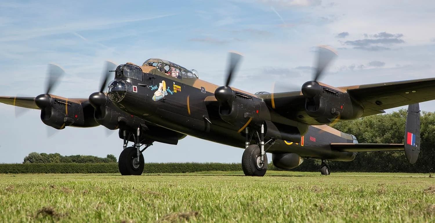 Avro Lancaster bomber 'Just Jane' (NX611) taxiing on the grass airfield at the Lincolnshire Aviation Heritage Centre, East Kirkby