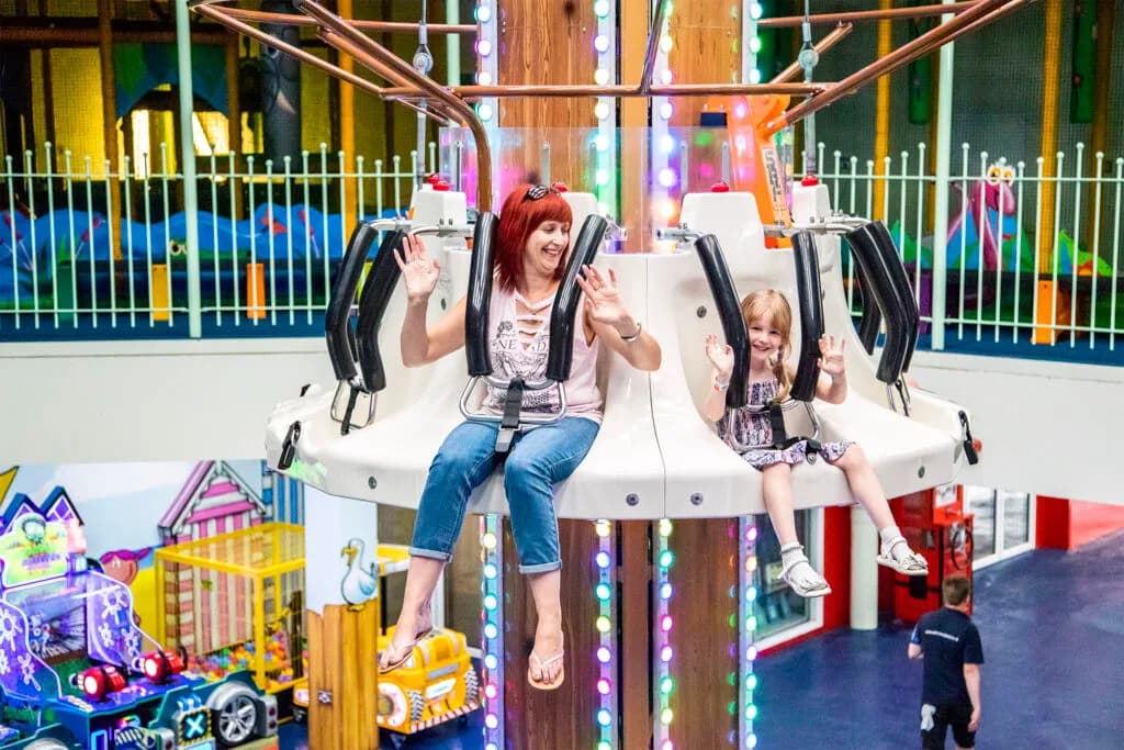 Indoor rides area at Funtopia with carousel and pirate ship
