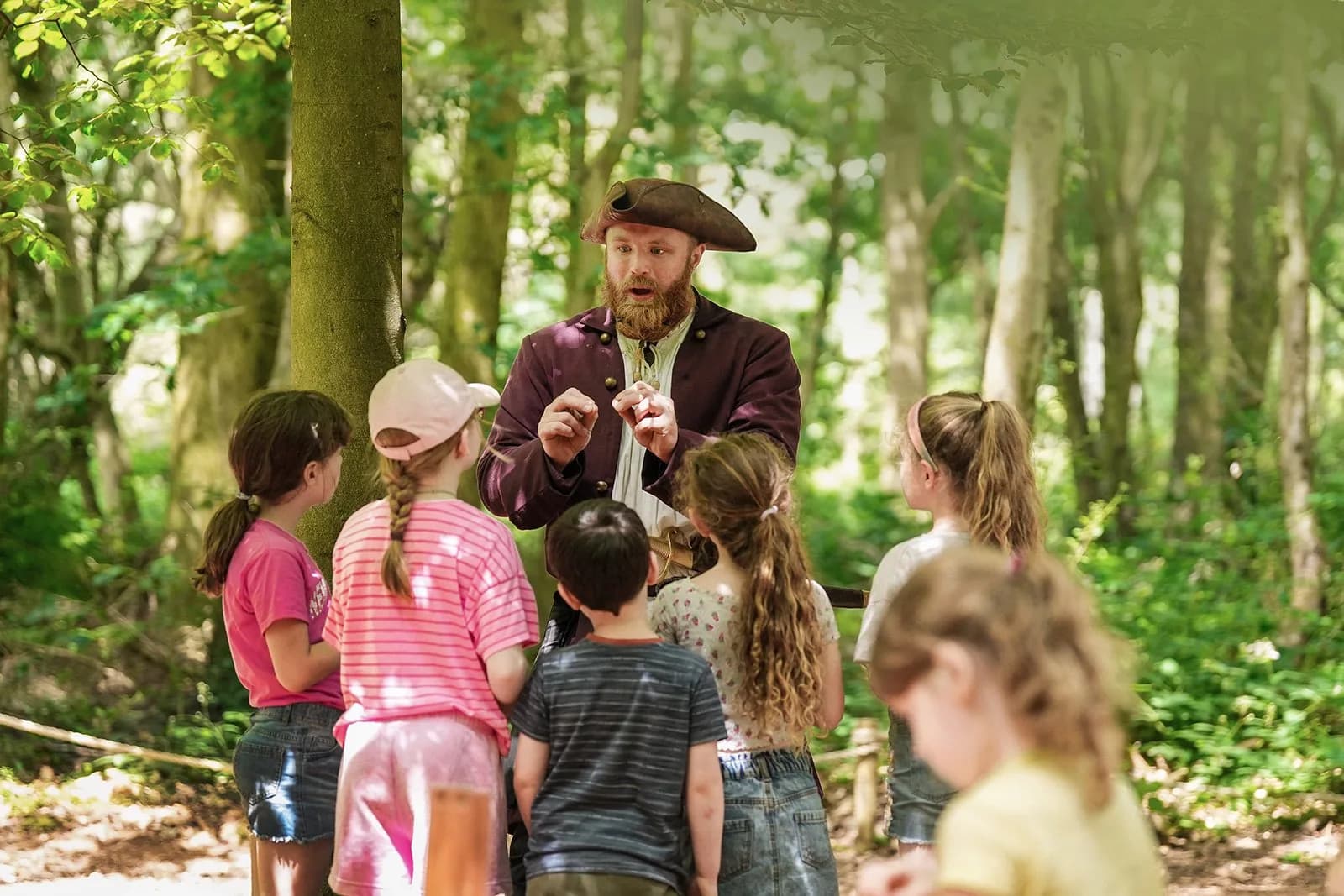 The Captain character with children at Wyvernwood's woodland campsite
