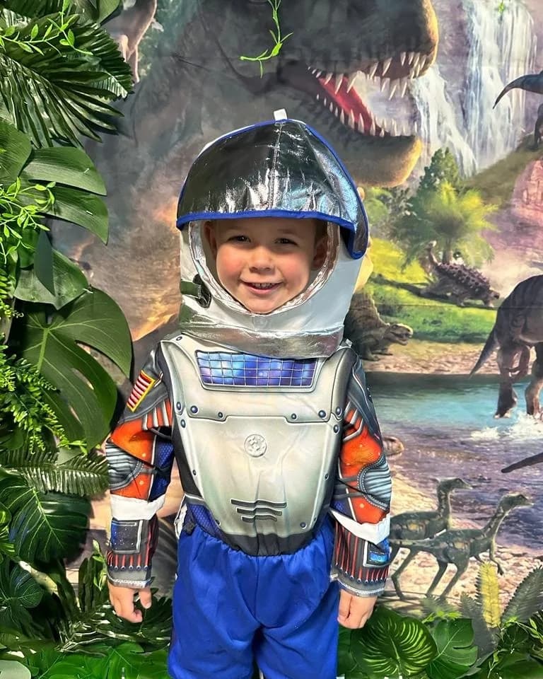 Child in astronaut costume in the role-play area at Inspired Play Town