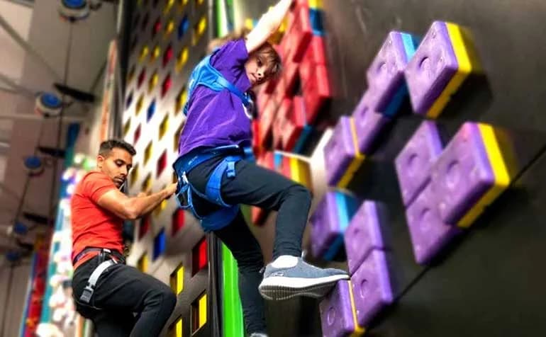 Children climbing at Clip n Climb Cambridge climbing centre