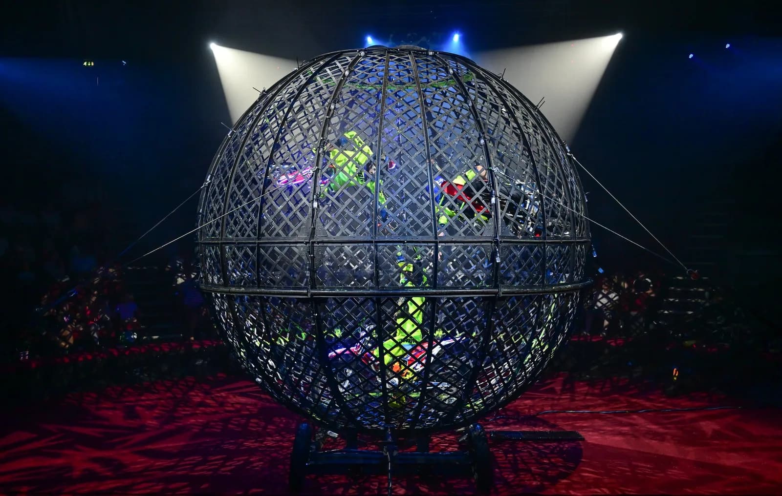 Motorbike Globe of Death stunt riders performing inside the sphere at Hippodrome Circus, Great Yarmouth