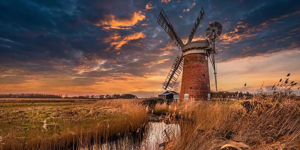 The Broads National Park - Horsey Mill at sunset, a classic Norfolk Broads landscape with windmill reflecting in water