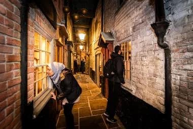 Visitors exploring the recreated Victorian Row street scene at Time and Tide Museum, Great Yarmouth