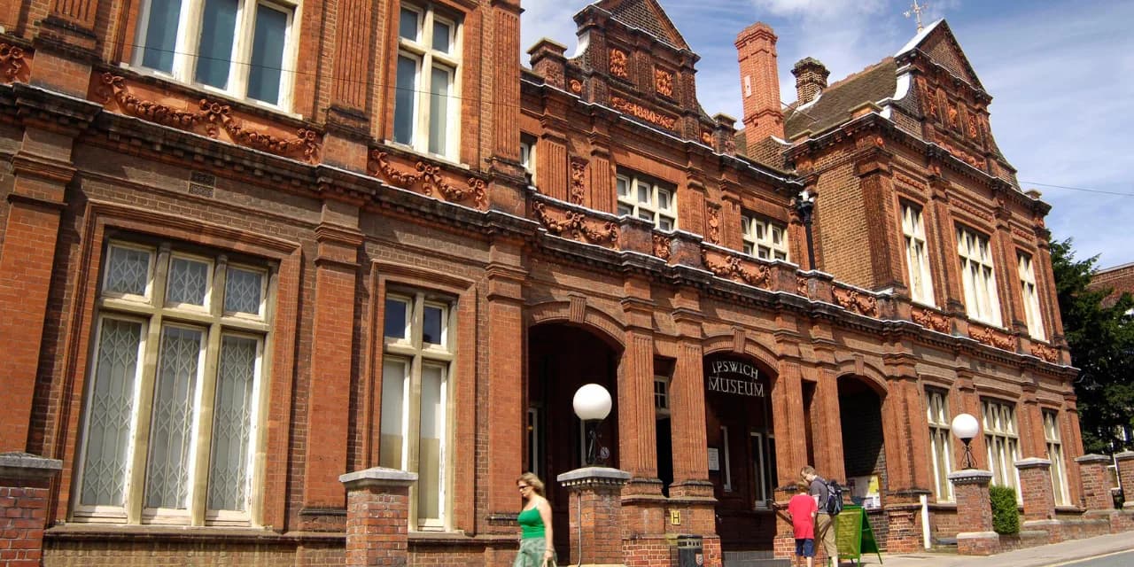 The historic Ipswich Museum building on High Street, a red brick Victorian building with ornate architectural detailing and arched entrance
