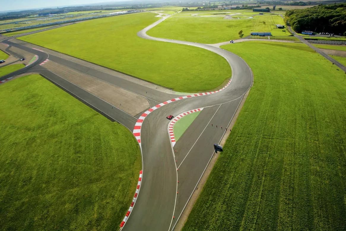 Bedford Autodrome motorsport circuit aerial view with cars on track