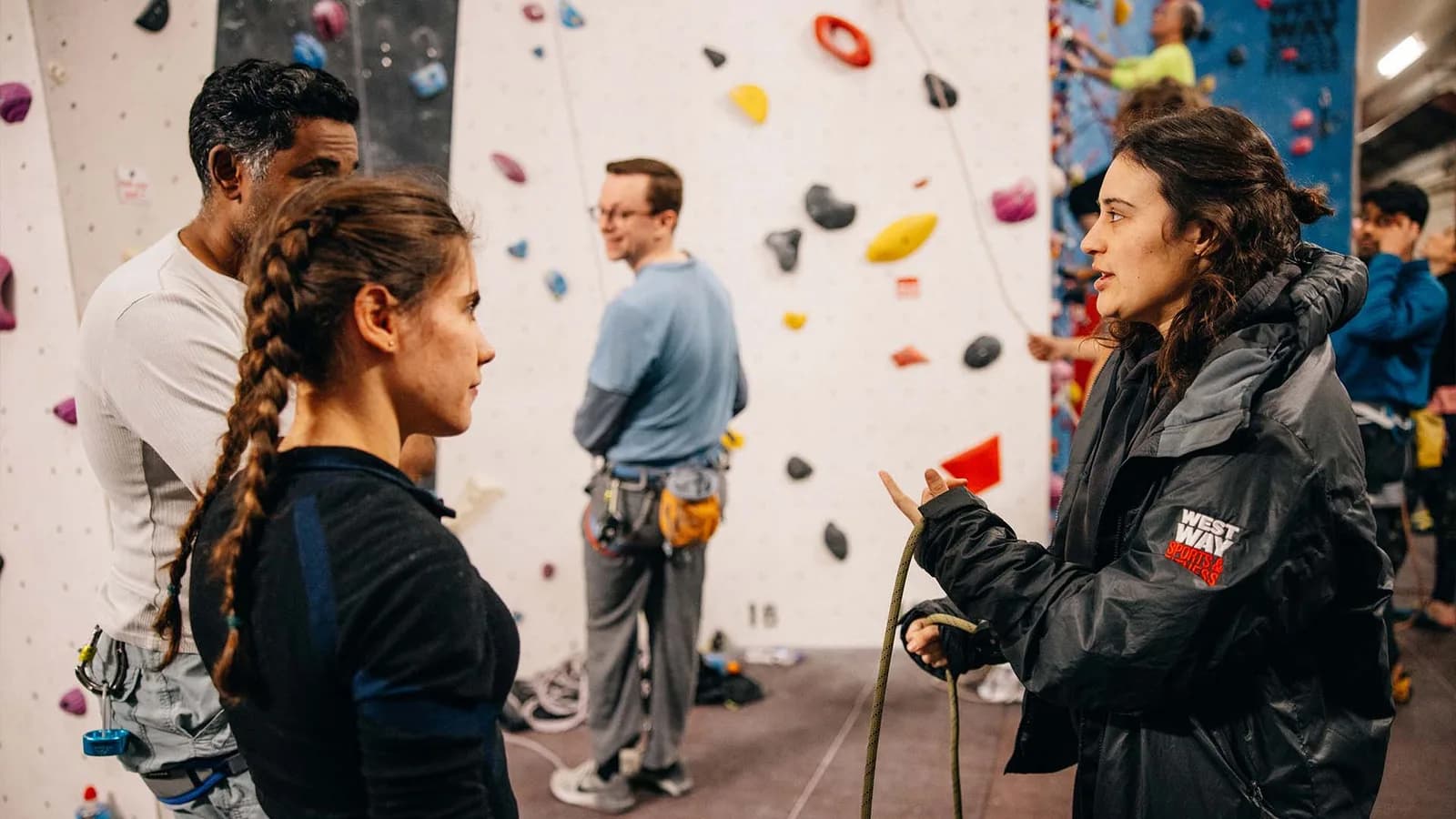Instructor helping a young pair climb the wall at Westway Sports Centre