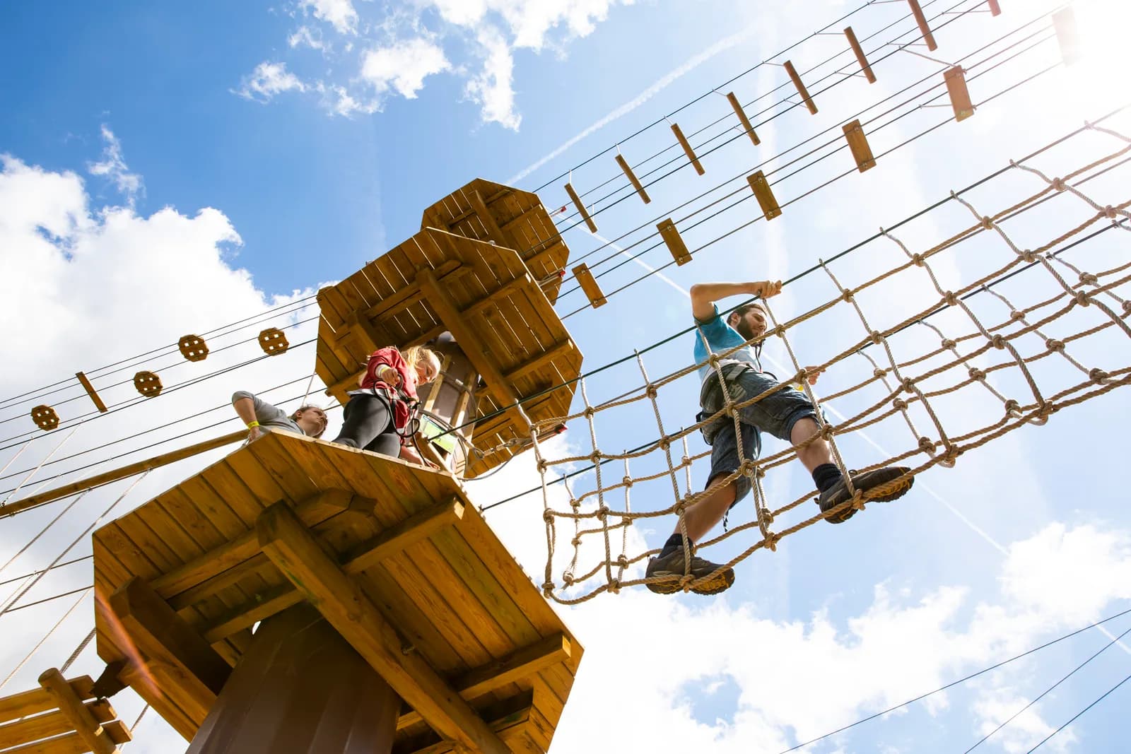 Person crossing a rope bridge on the Go Ape high ropes course at Alexandra Palace