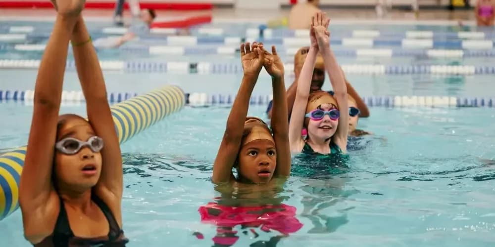 Children taking part in a swimming lesson at Manchester Aquatics Centre