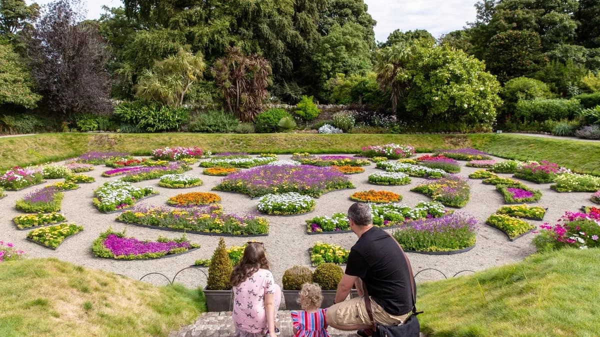 Family in the sunk garden at Castle Ward in summer