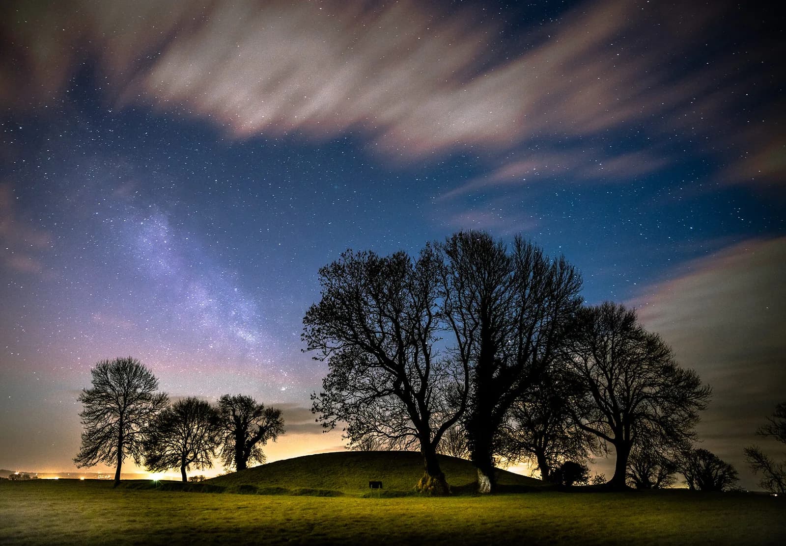 Navan Fort mound under starry night sky with Milky Way
