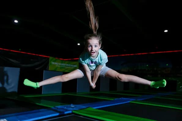 Girl jumping on trampoline at Flip Out Glasgow - the main trampoline arena