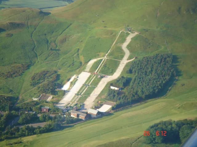 Downhill view of Midlothian Snowsports Centre at Hillend, with Edinburgh and Arthurs Seat in the distance