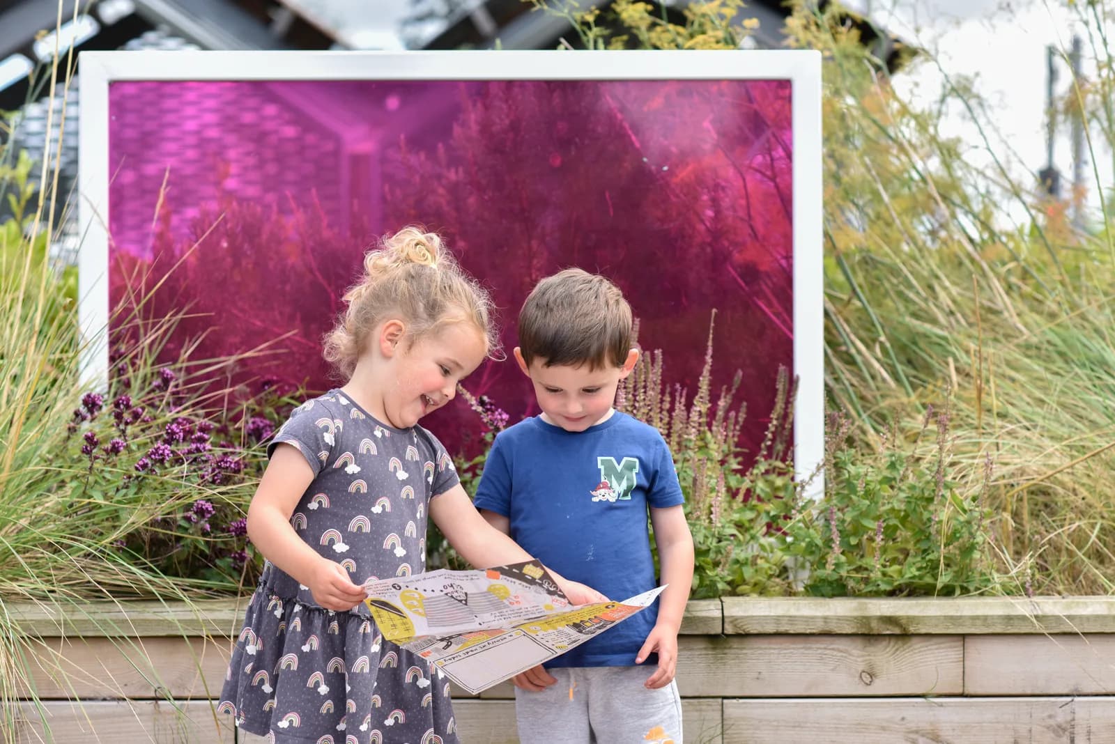 Two children enjoying an outdoor activity trail at V&A Dundee