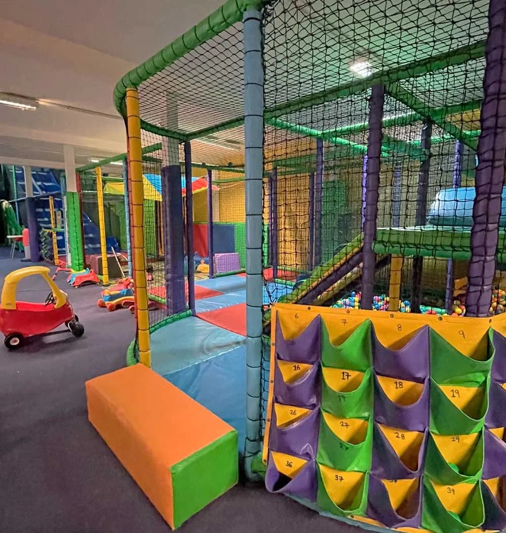Multi-level indoor soft play structure with ball pit and climbing frames at Wonderland Play Newton Abbot