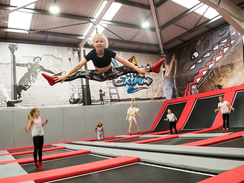 Children jumping on interconnected trampolines at Air Extreme trampoline park in Barnstaple