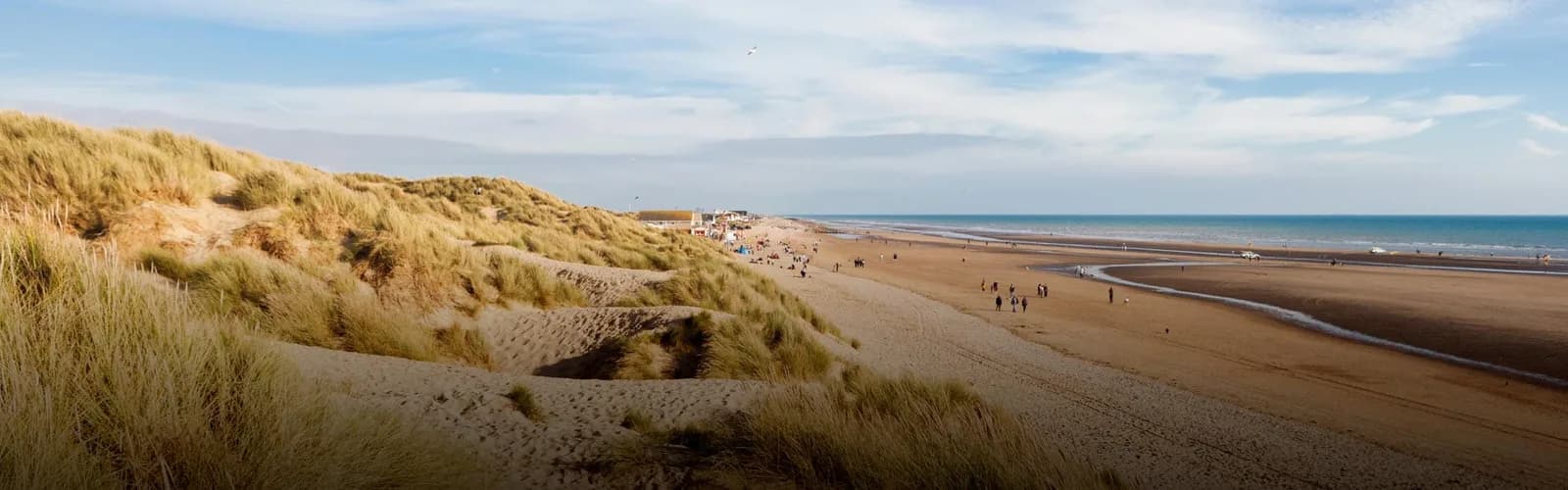 Golden sand dunes of Camber Sands beach beside the holiday park