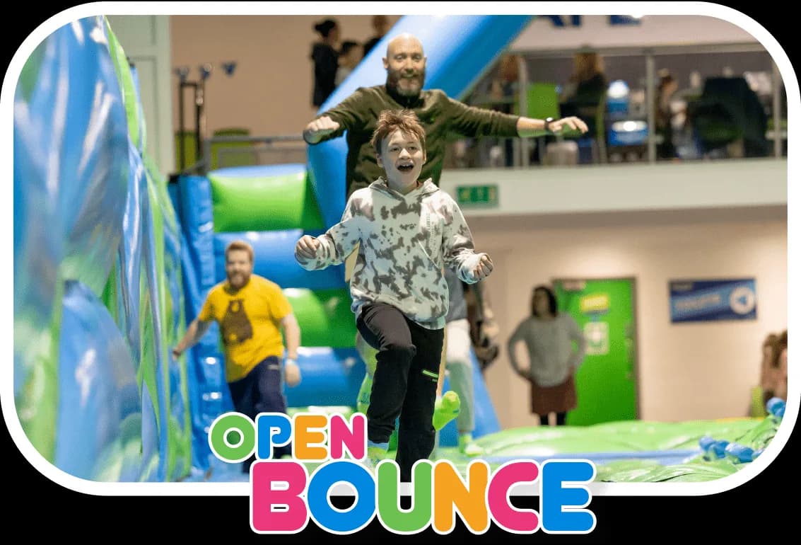 Children bouncing on giant inflatable slides and obstacles in the open bounce arena at Innoflate Newport