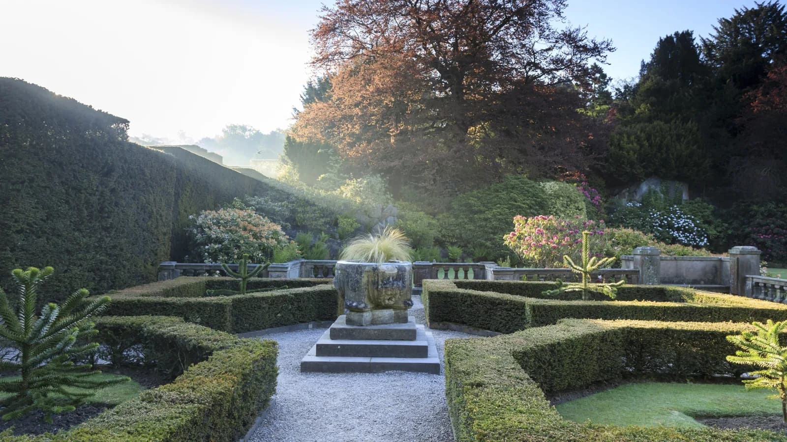 A winter view of Biddulph Grange Garden showing the snow-covered grounds and pathways