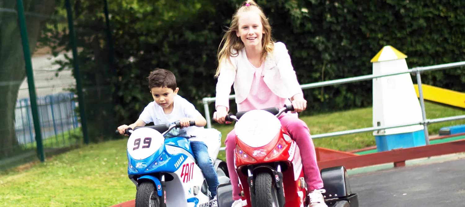 Kids racing mini F1-style cars at Playland Fun Park, Stourport-on-Severn