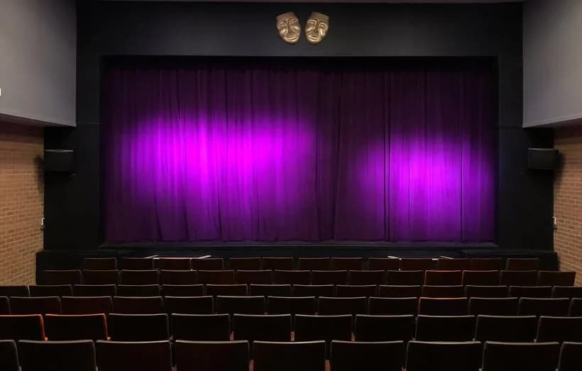 Conquest Theatre Bromyard auditorium and stage with purple curtains
