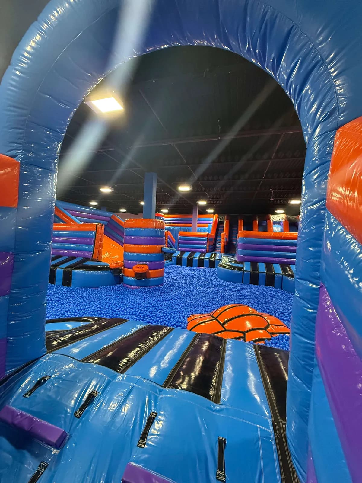 Indoor inflatable arena at Inflata Nation Hull with giant ball pit and inflatable slides