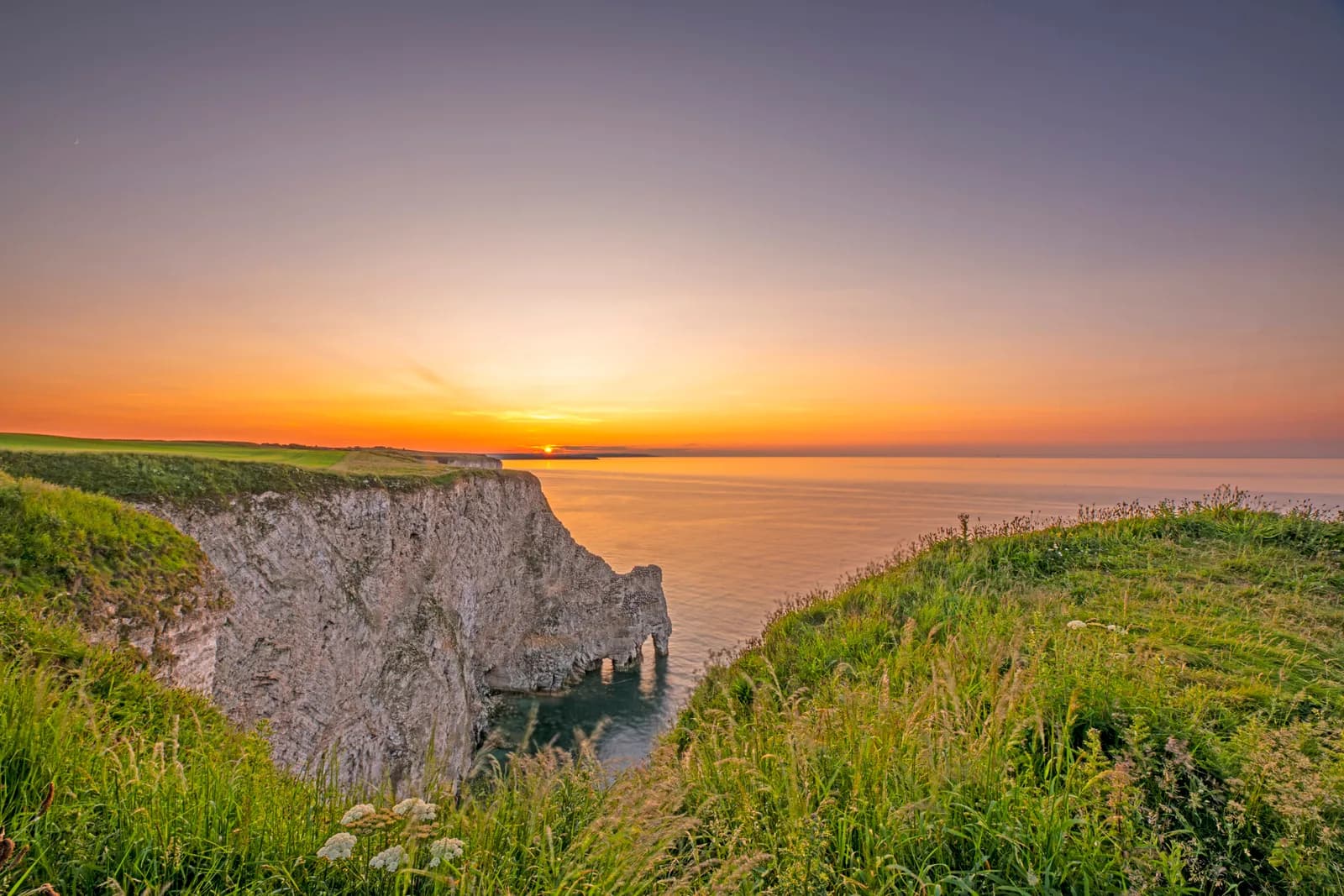 Bempton Cliffs at sunset showing the chalk cliffs, arch rock formation and the North Sea
