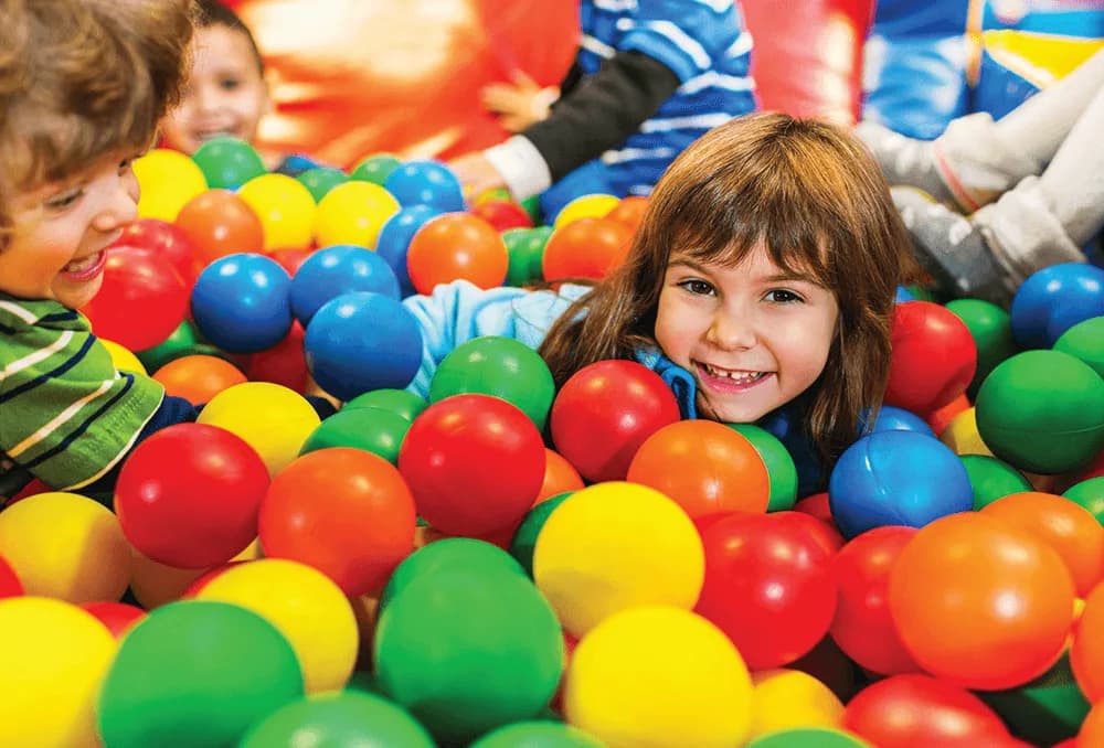 Children playing in soft play ball pit at Play World Washington