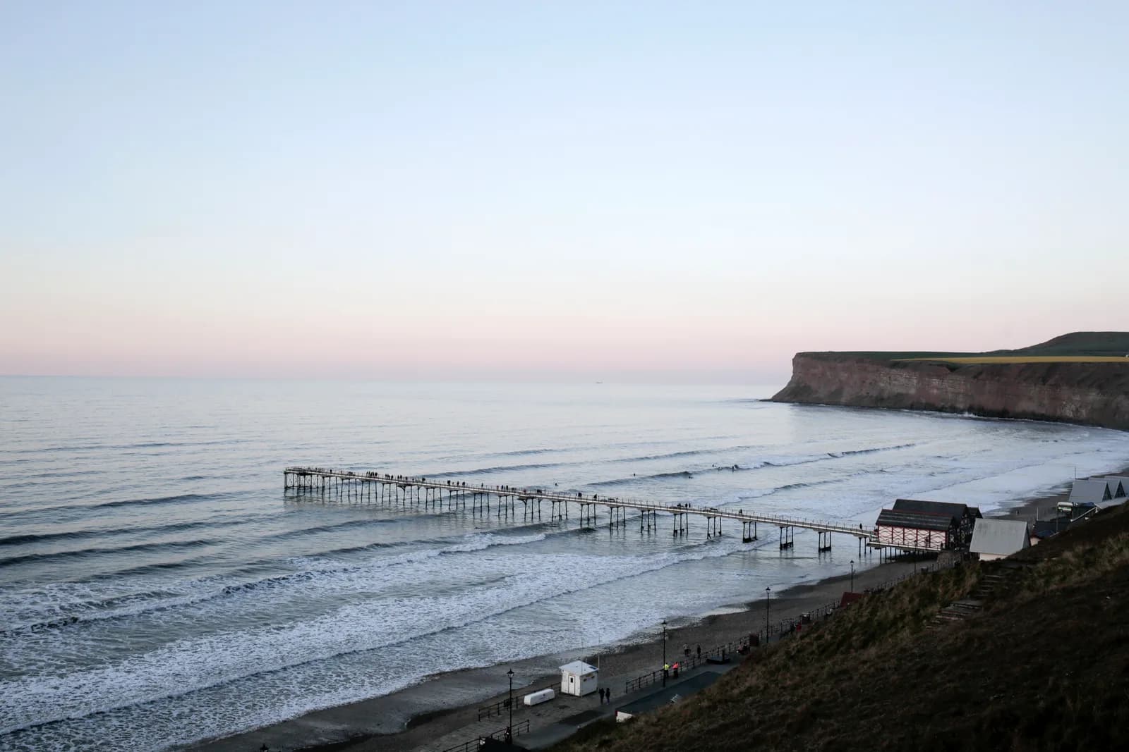 Saltburn beach and pier seen from the clifftop with Huntcliff in the background