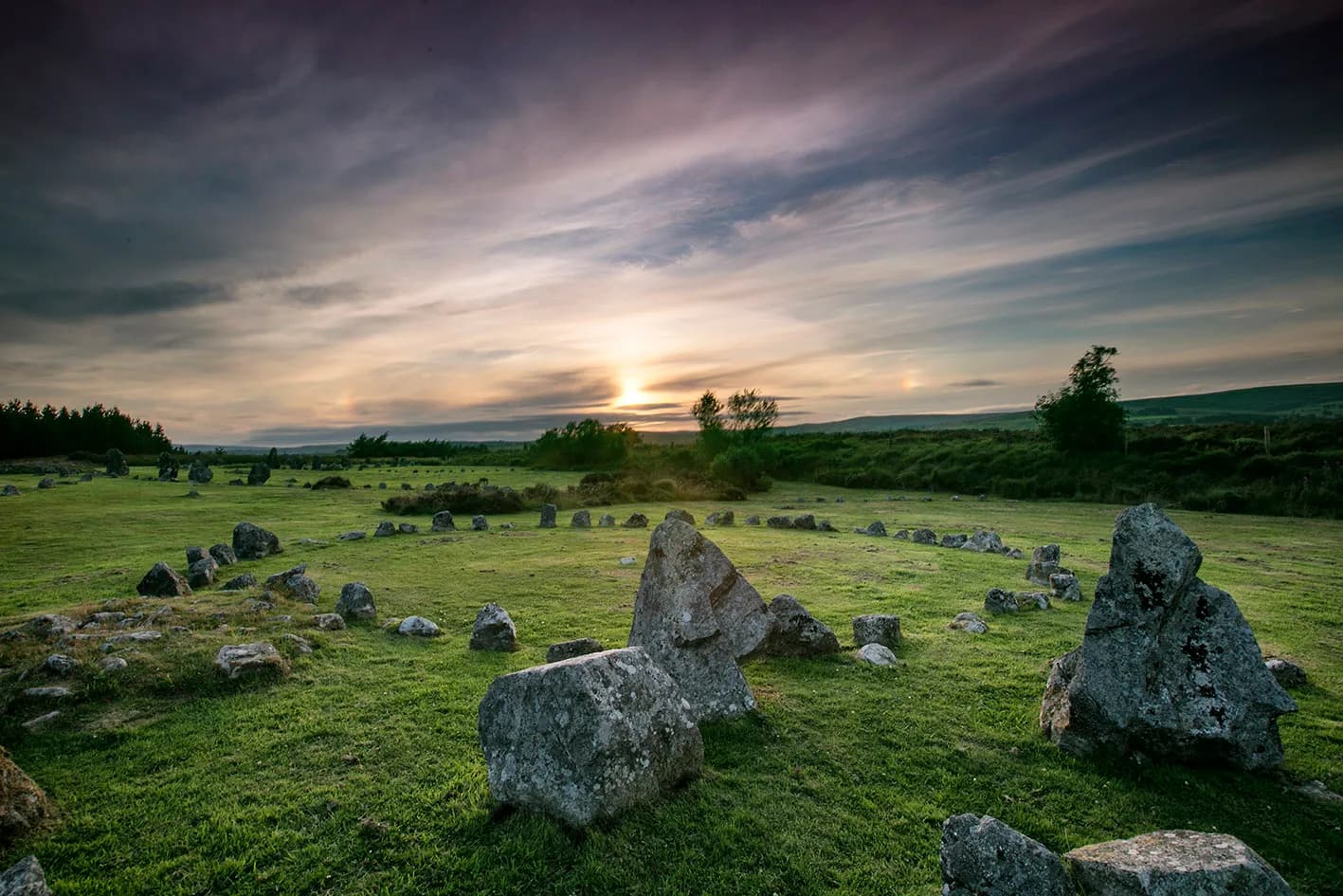 A stone circle at Beaghmore on a sunny day with moorland in the background