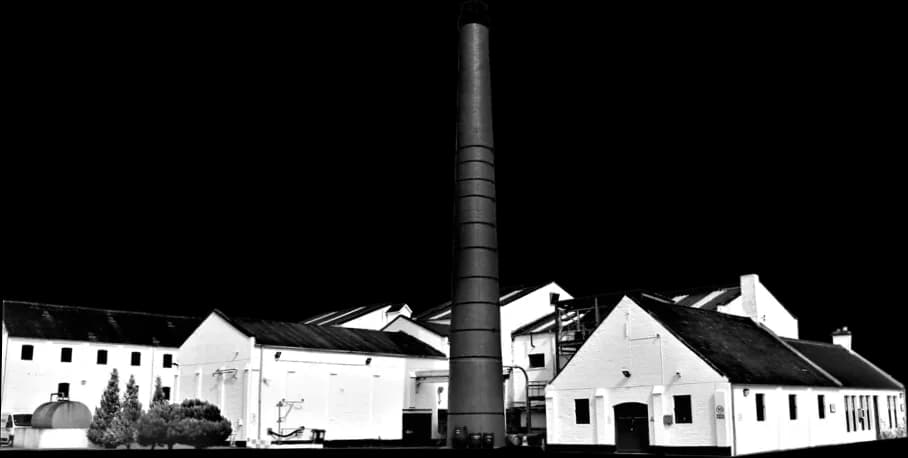 Benromach Distillery exterior view with traditional whitewashed buildings