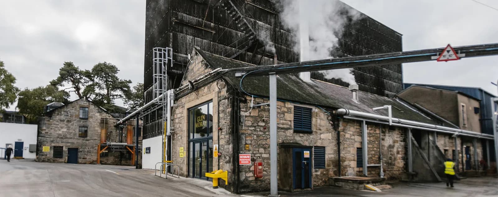 Exterior view of Glen Moray Distillery visitor centre entrance with GLEN MORAY signage on Bruceland Road, Elgin