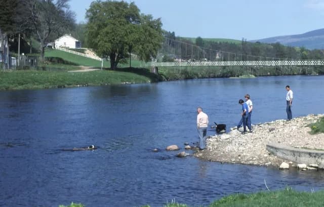 The River Spey at Aberlour, a wide river flowing through green Speyside countryside