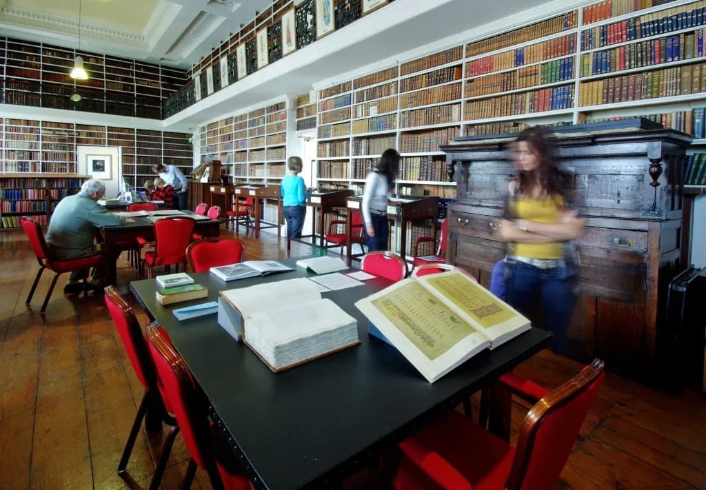 Interior of the Long Room at Armagh Robinson Library showing historic books and display cabinets