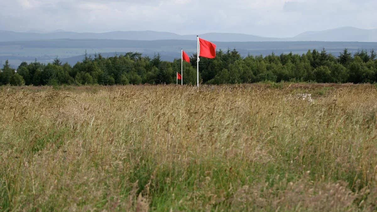 Culloden Battlefield moorland with the red Jacobite-line flags