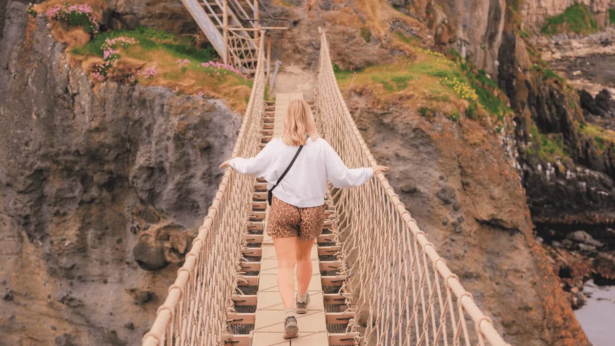 A visitor taking in the views from Carrick-a-Rede Rope Bridge, County Antrim