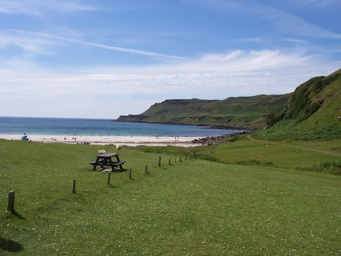 White sand beach at Calgary Bay on the Isle of Mull with machair grassland and low hills