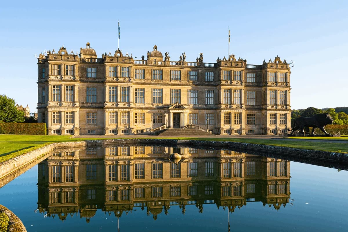 Longleat House exterior with reflecting pool and lion statue