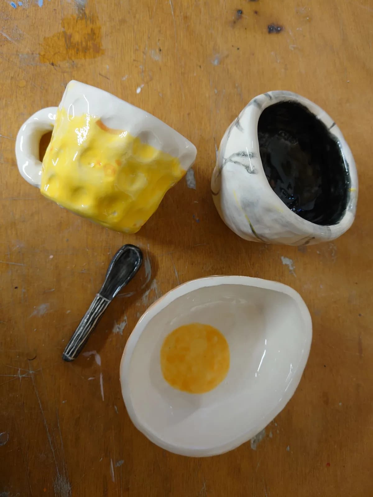 Hand-painted ceramics on the workbench at Doodles pottery studio, Edinburgh