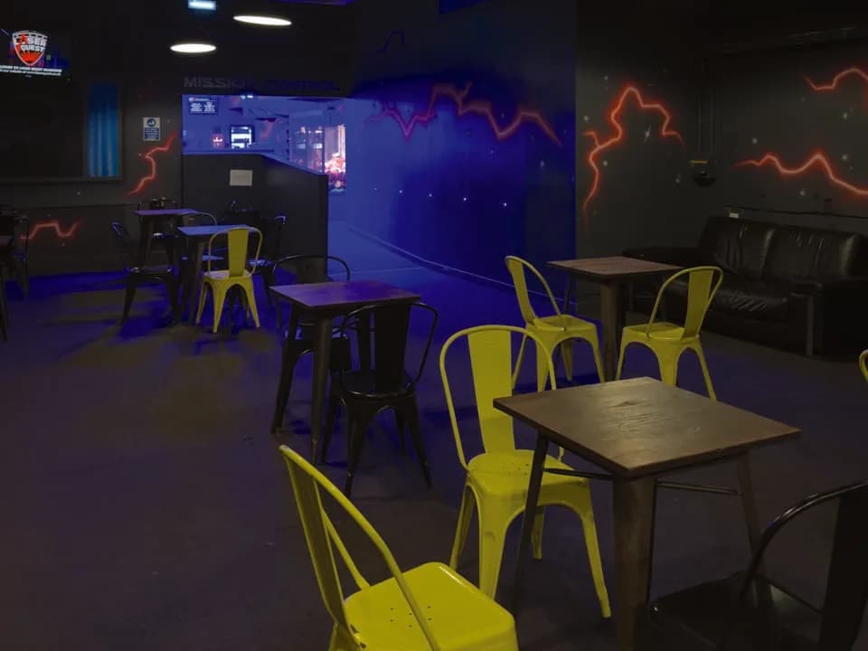Laser tag arena at Laser Quest Glasgow with futuristic maze, fog and UV lighting