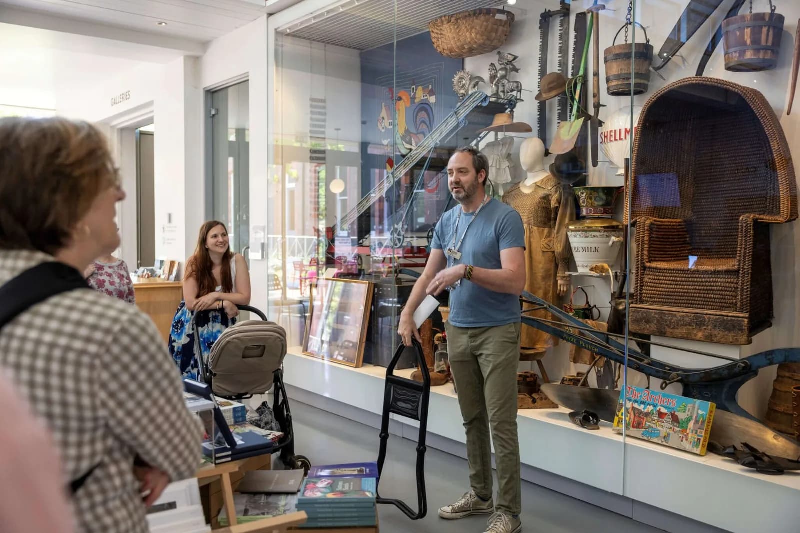 MERL curator Ollie Douglas standing in front of the Welcome Case in the galleries at The Museum of English Rural Life, Reading