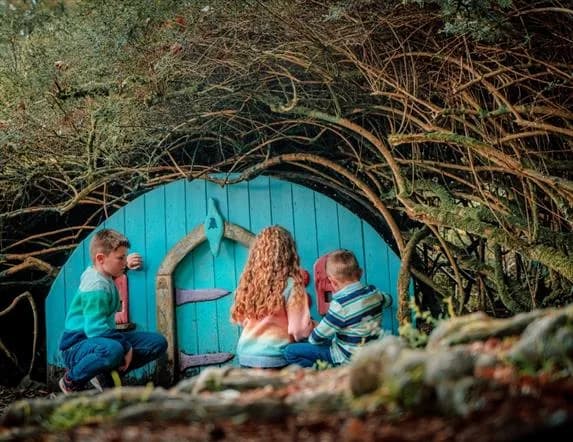 Children at a fairy house door on Fionn's Giant Adventure trail, Slieve Gullion Forest Park
