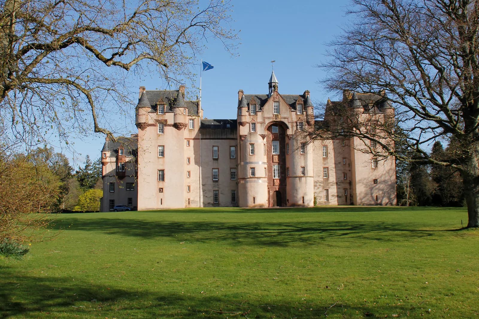 Fyvie Castle exterior front view with lawns and trees