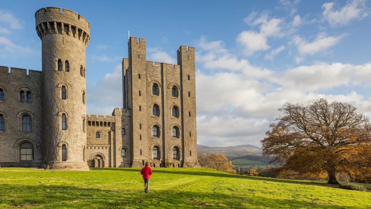 Penrhyn Castle, the neo-Norman National Trust castle near Bangor, Gwynedd, seen across the grounds in autumn
